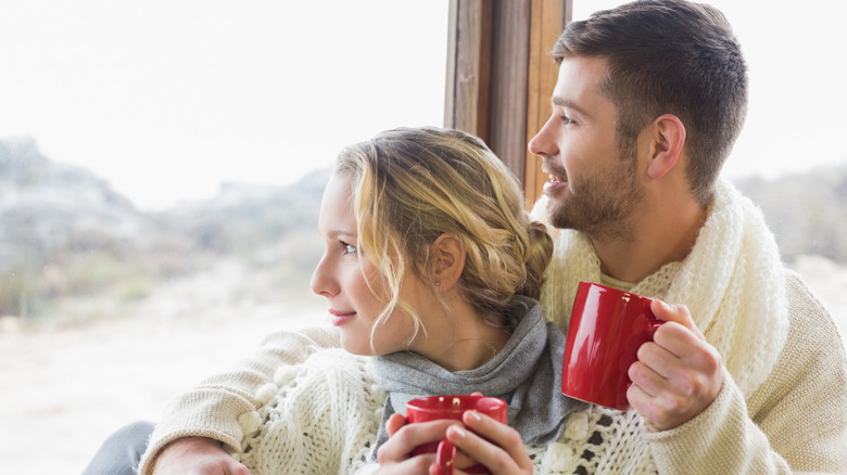 A couple getting cozy in a cabin