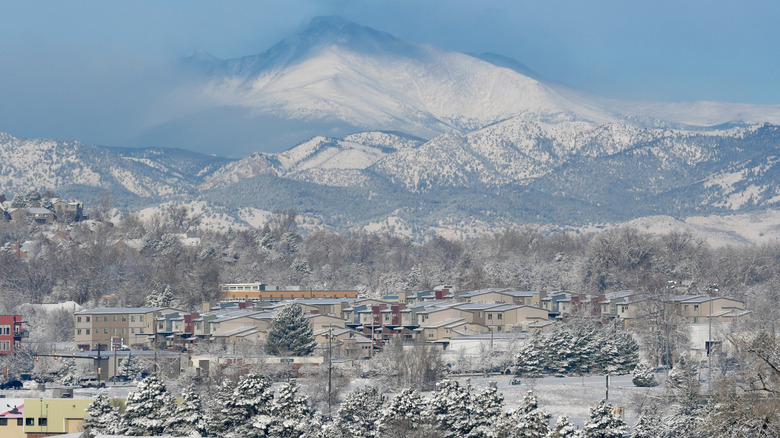 the snow-covered town of Louisville in Boulder County with the Rocky Mountains in the background in Colorado