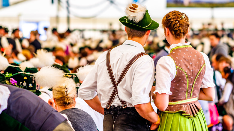 A couple from behind in traditonal Austrian costumes